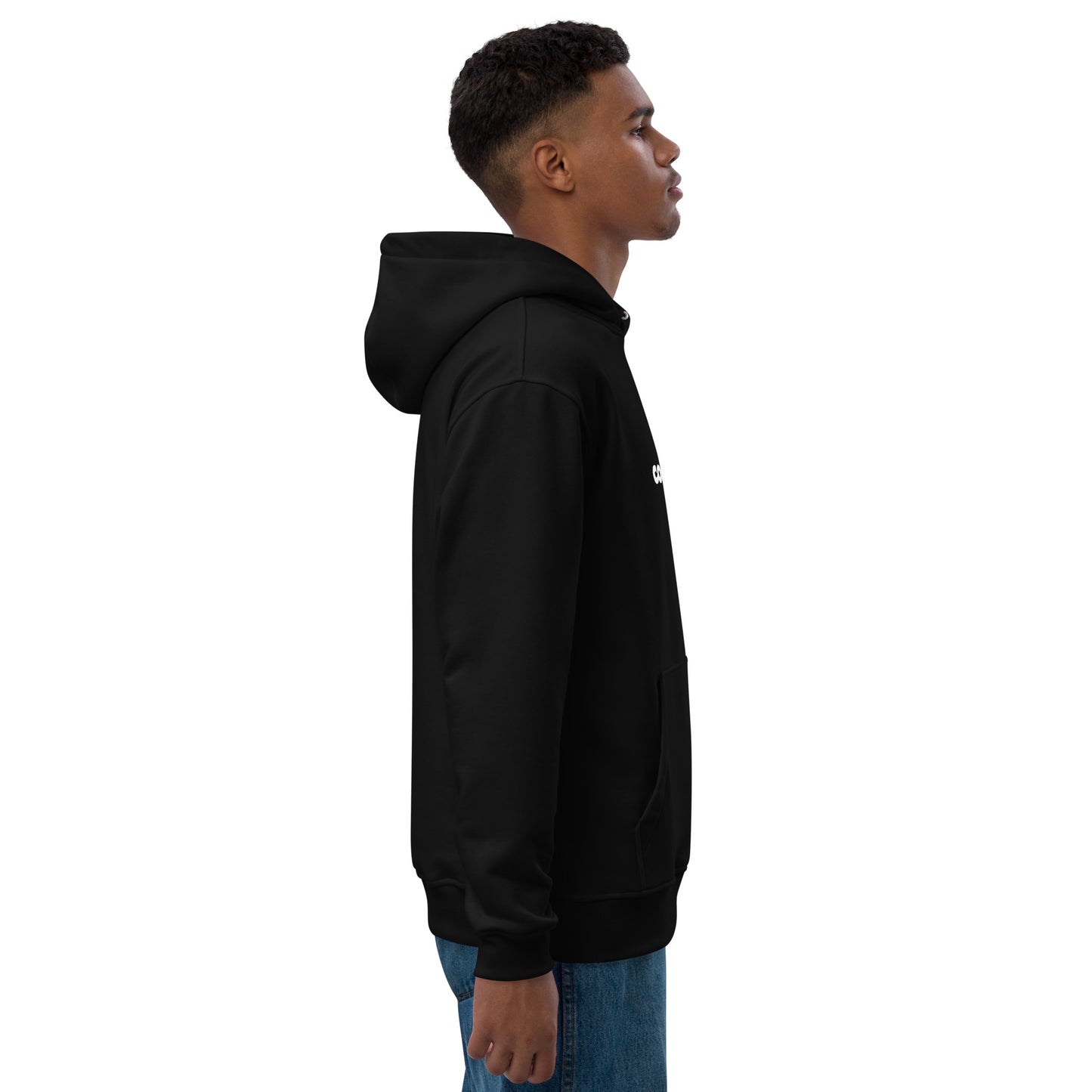 side view of a black man wearing a black hoodie with the Coliving Residences Riga logo