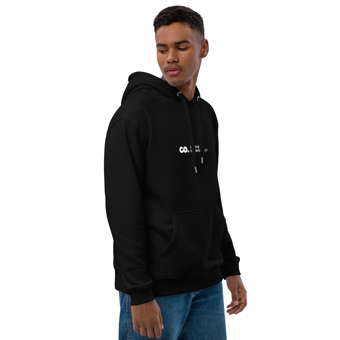 ide view of a black man wearing a black hoodie with the Coliving Residences Riga logo