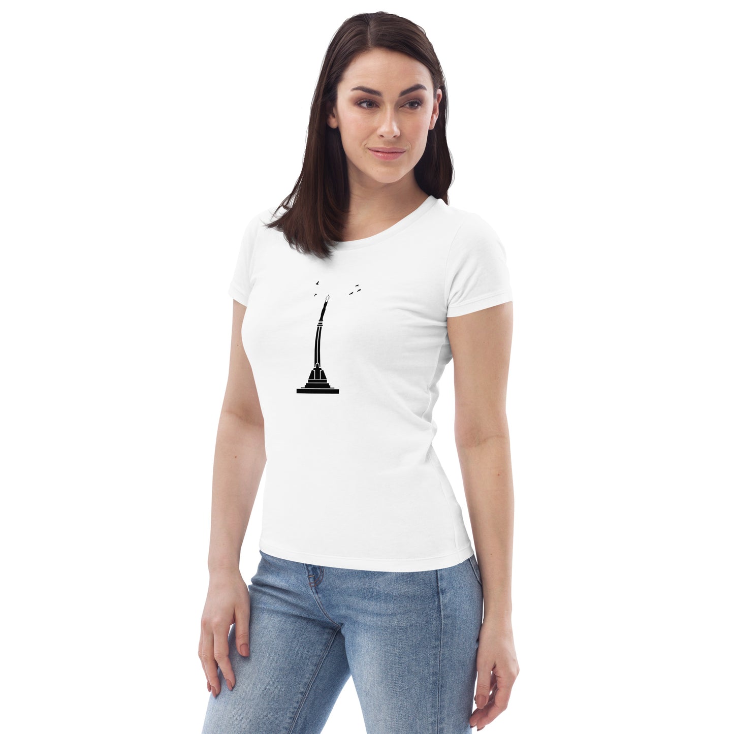 Front view of a brunette woman in a white t-shirt, with Riga's Liberty Monument visible