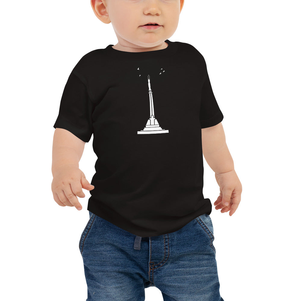 front of baby wearing a black t-shirt featuring Riga's Freedom momument