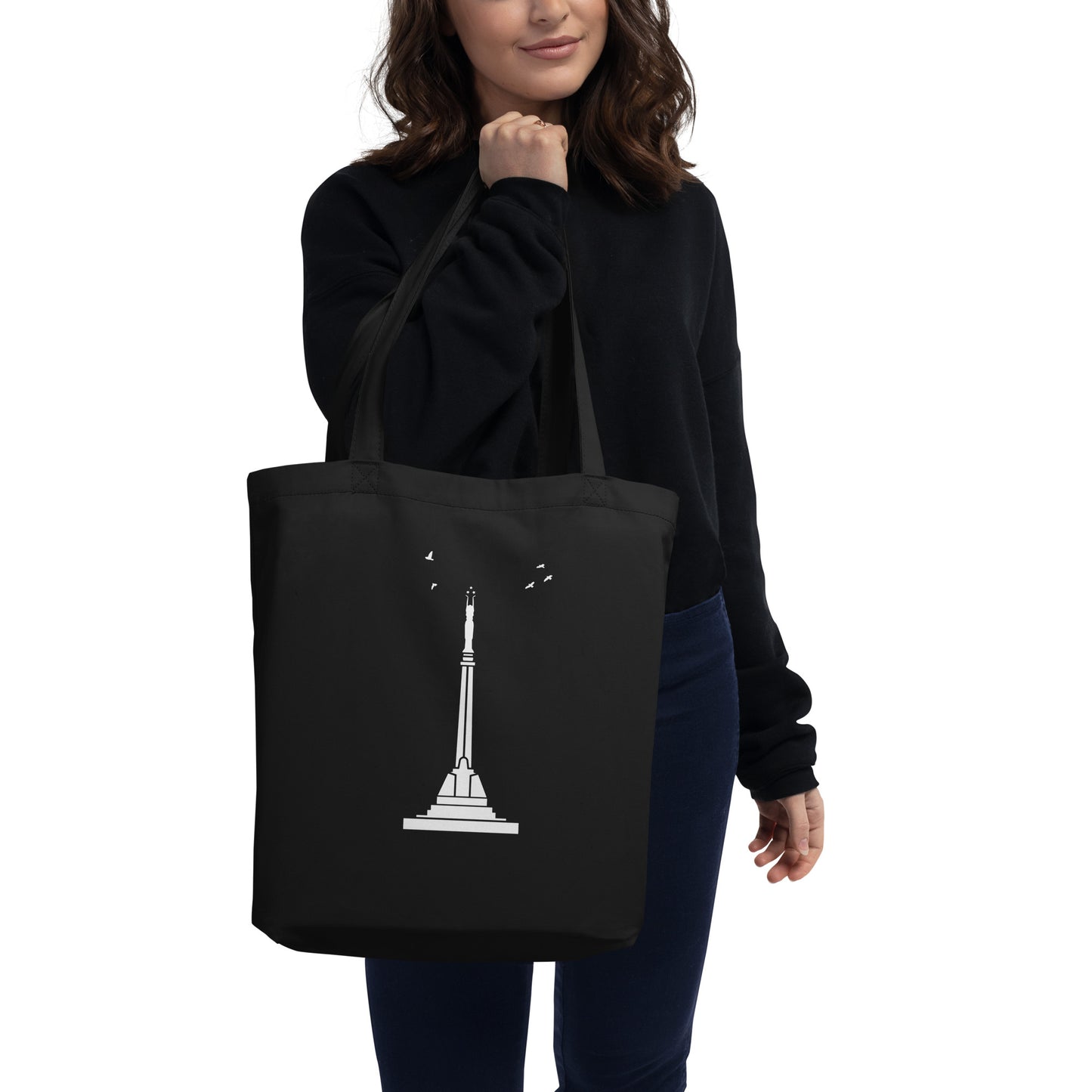 Back view of a girl holding a black eco-tote bag