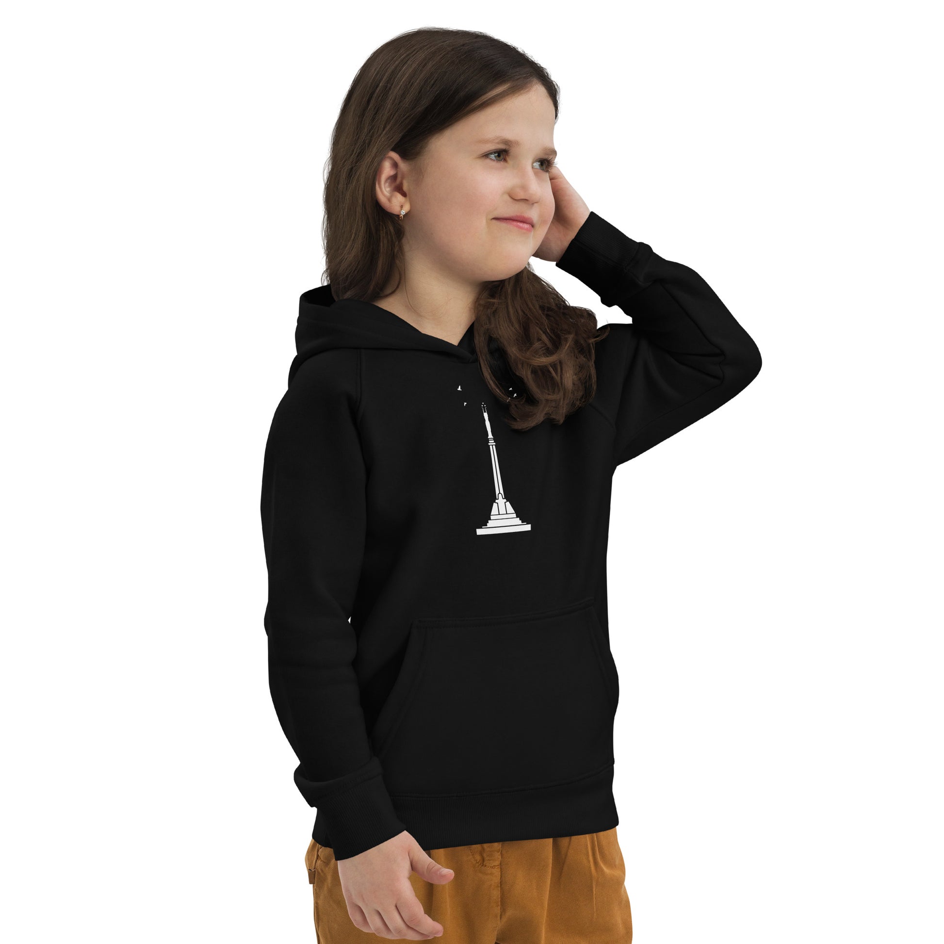 Front view of a little girl wearing a black hoodie featuring Riga's Liberty Monument