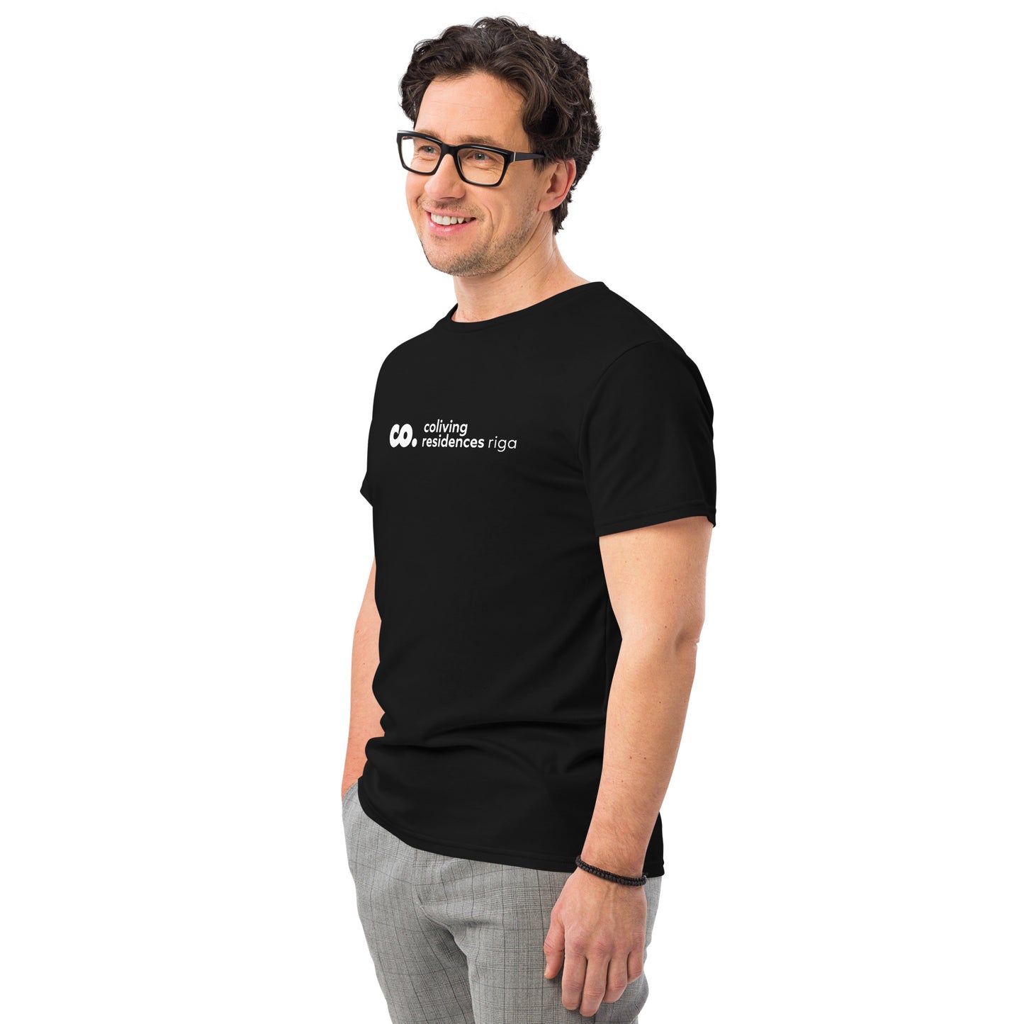 side view of a white man wearing a black t-shirt with logo of coliving residences riga