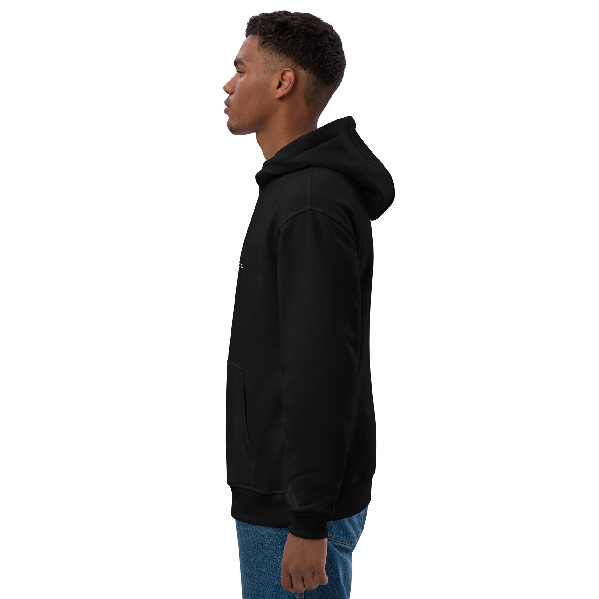 side view of a black man wearing a black hoodie with the Coliving Residences Riga logo