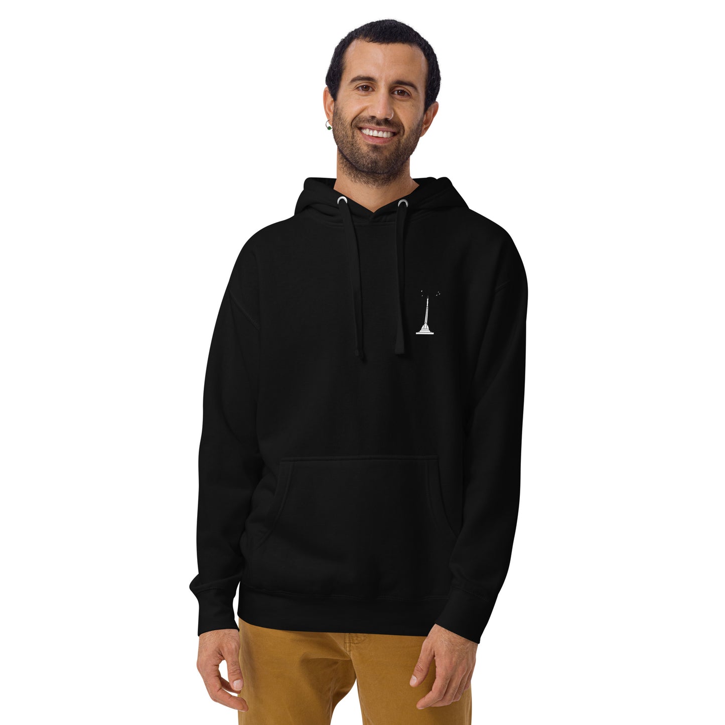 front view of a white man wearing a unisex premium black hoodie featuring Riga's Liberty Monument on the left chest